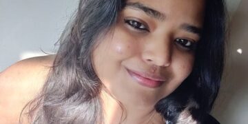 Persona montando en bicicleta por un carril bici en la ciudad