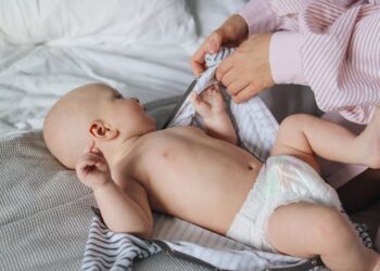 Bebé jugando con juguetes de colores durante una sesión de estimulación temprana